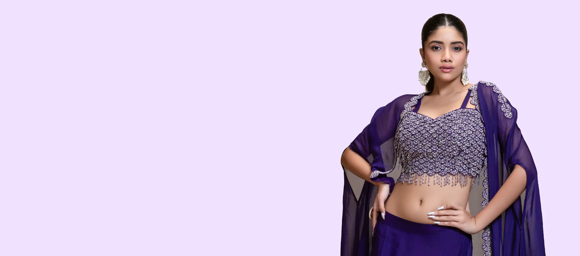 RUDRAYANI model wearing a deep violet hand-embroidered lehenga