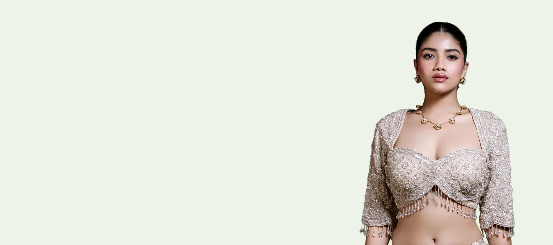 RUDRAYANI model wearing an ivory hand-embroidered blouse